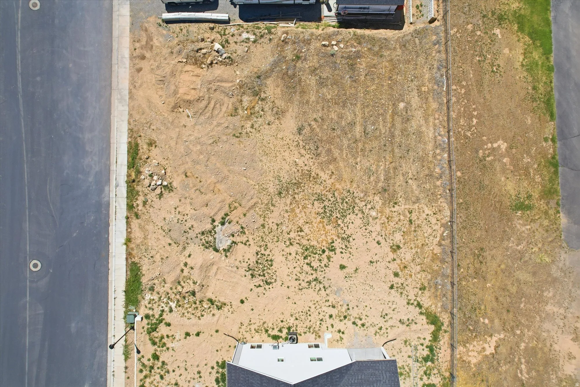Expansive undeveloped land parcel featuring direct road frontage and a newly constructed sidewalk