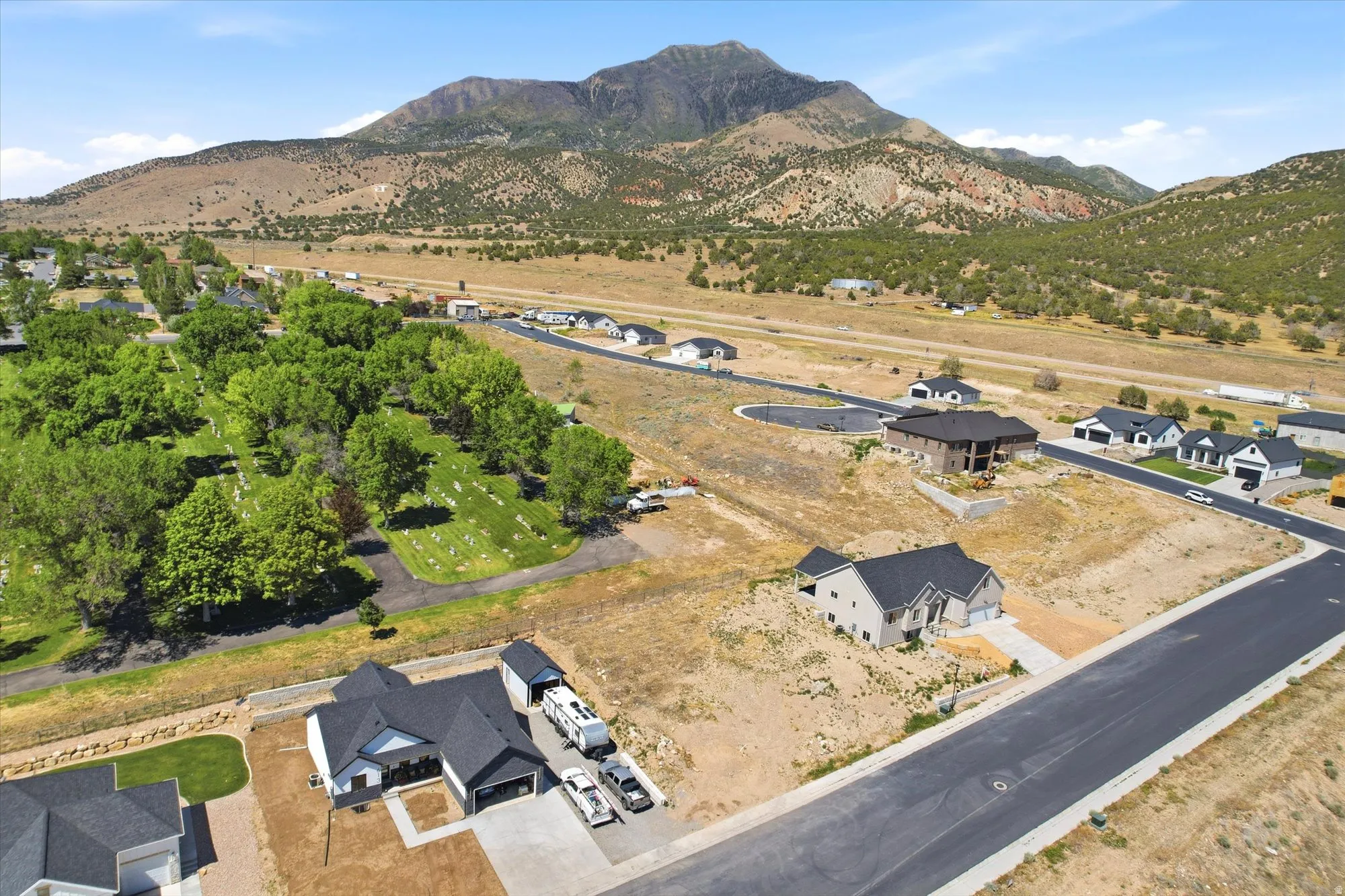 Expansive mountain backdrop with scattered residential properties