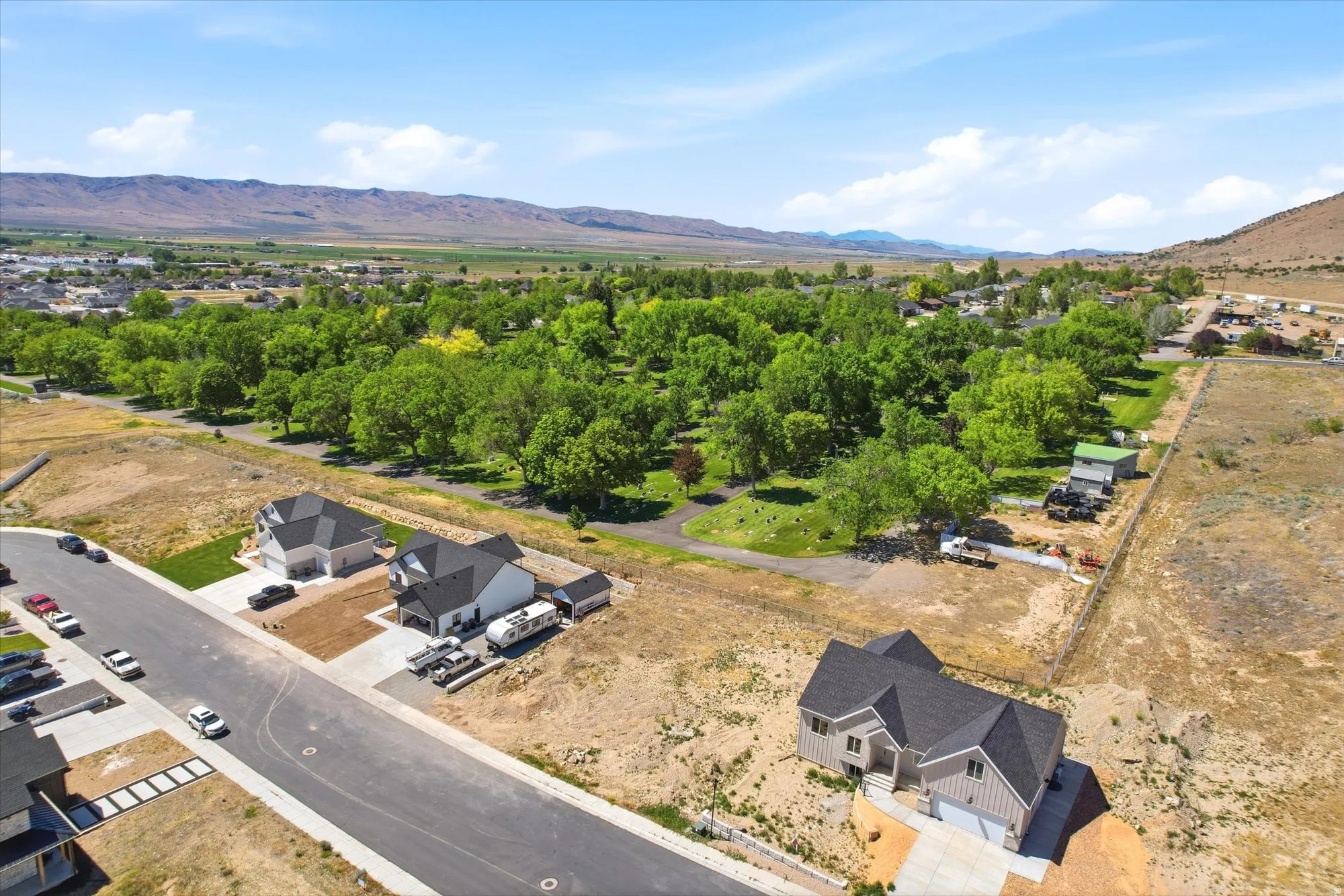 Aerial perspective showcasing a developing residential area with mountainous backdrops