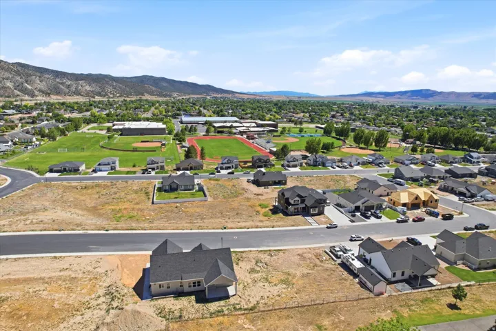 Expansive suburban development with new construction residential properties and mountain backdrops