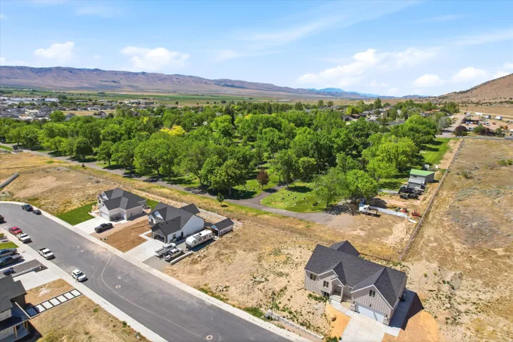 Aerial perspective showcasing a developing residential area with mountainous backdrops