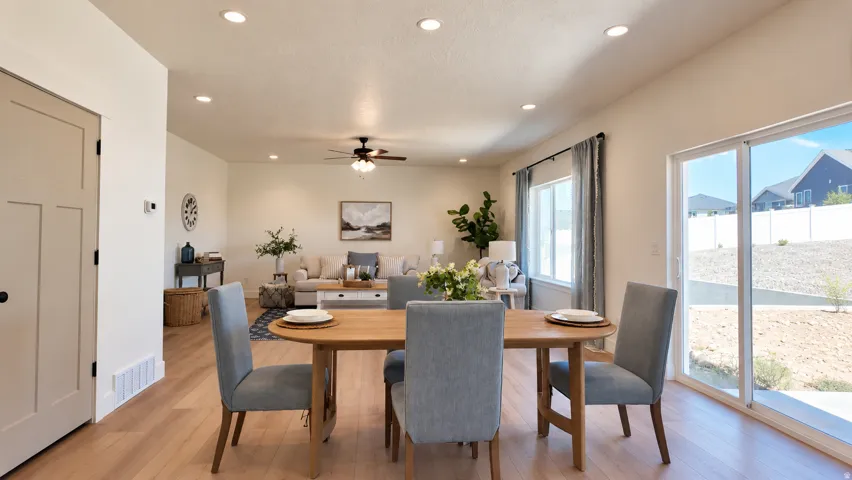 Open-concept living area featuring wood-finish flooring, recessed lighting, and a ceiling fan