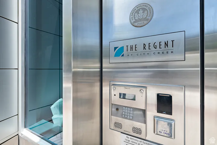 Exterior entry system featuring a sleek stainless steel panel, integrated intercom, and keycard access