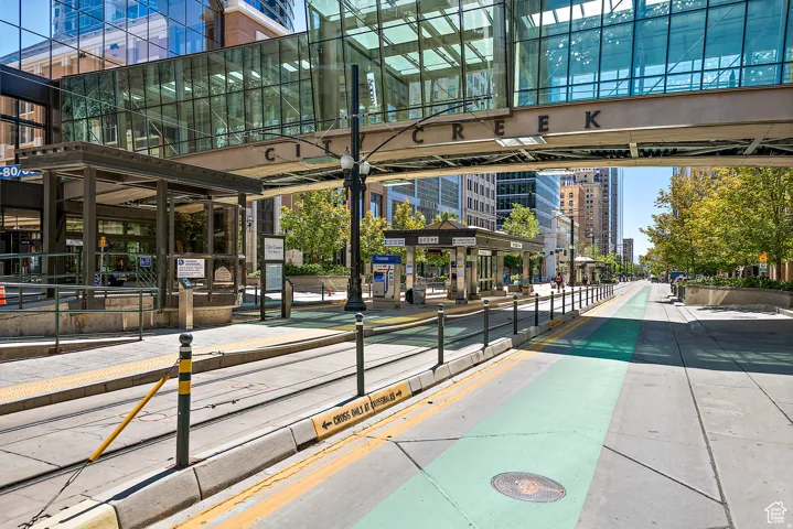 Urban streetscape with tram tracks and a designated green lane