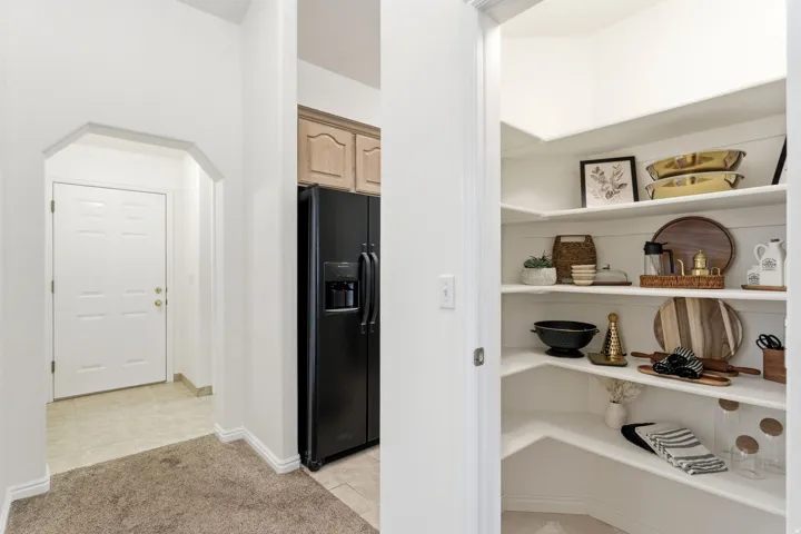 Integrated pantry with built-in shelving, providing extensive storage