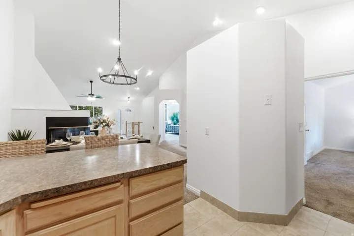 Kitchen island with wood-finish cabinetry and a stone-look countertop