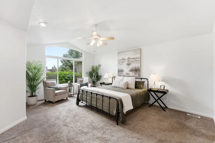 Spacious room with vaulted ceilings and a large arched window