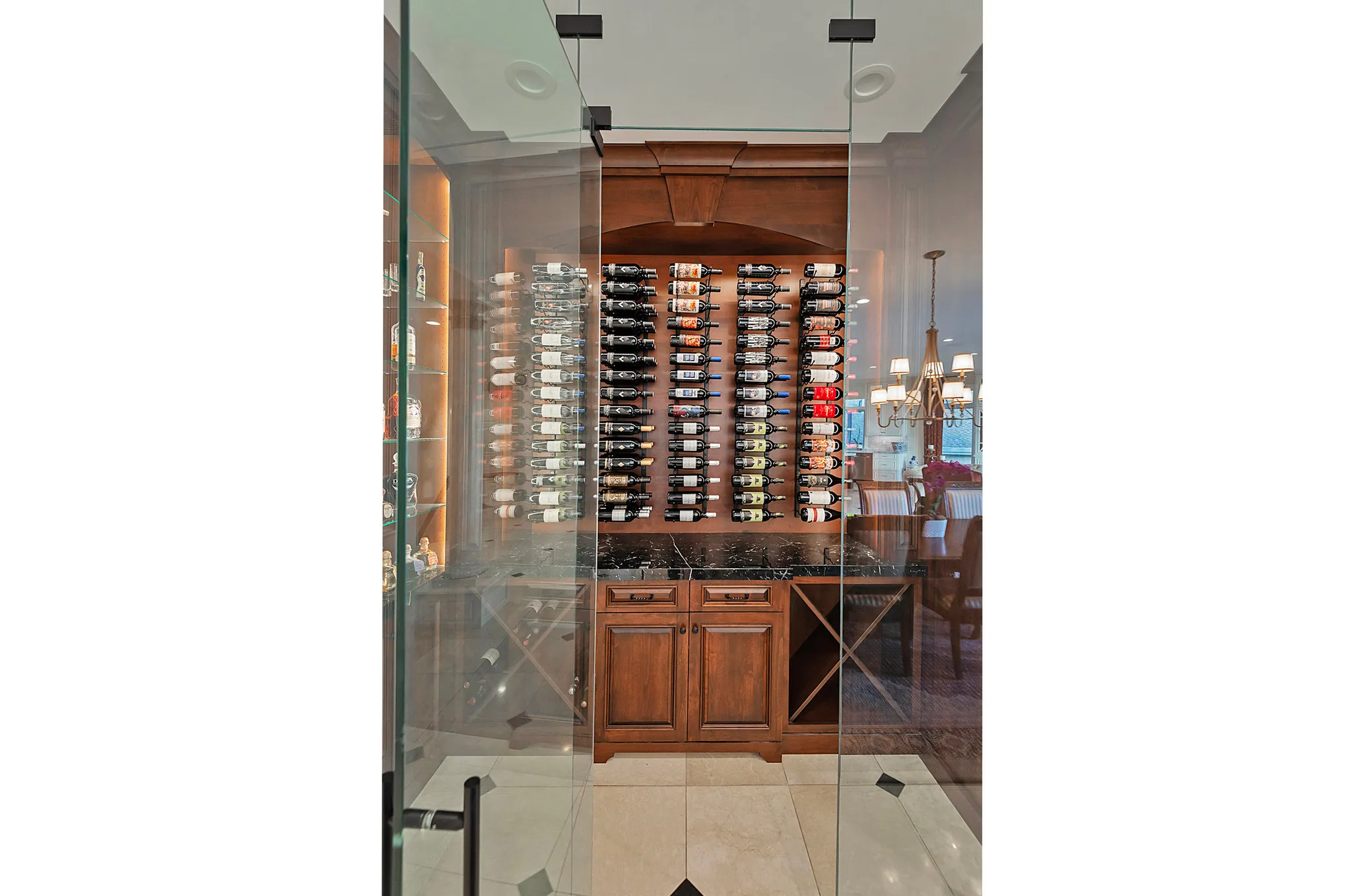 Dedicated wine room featuring a glass enclosure and a built-in wooden cabinet