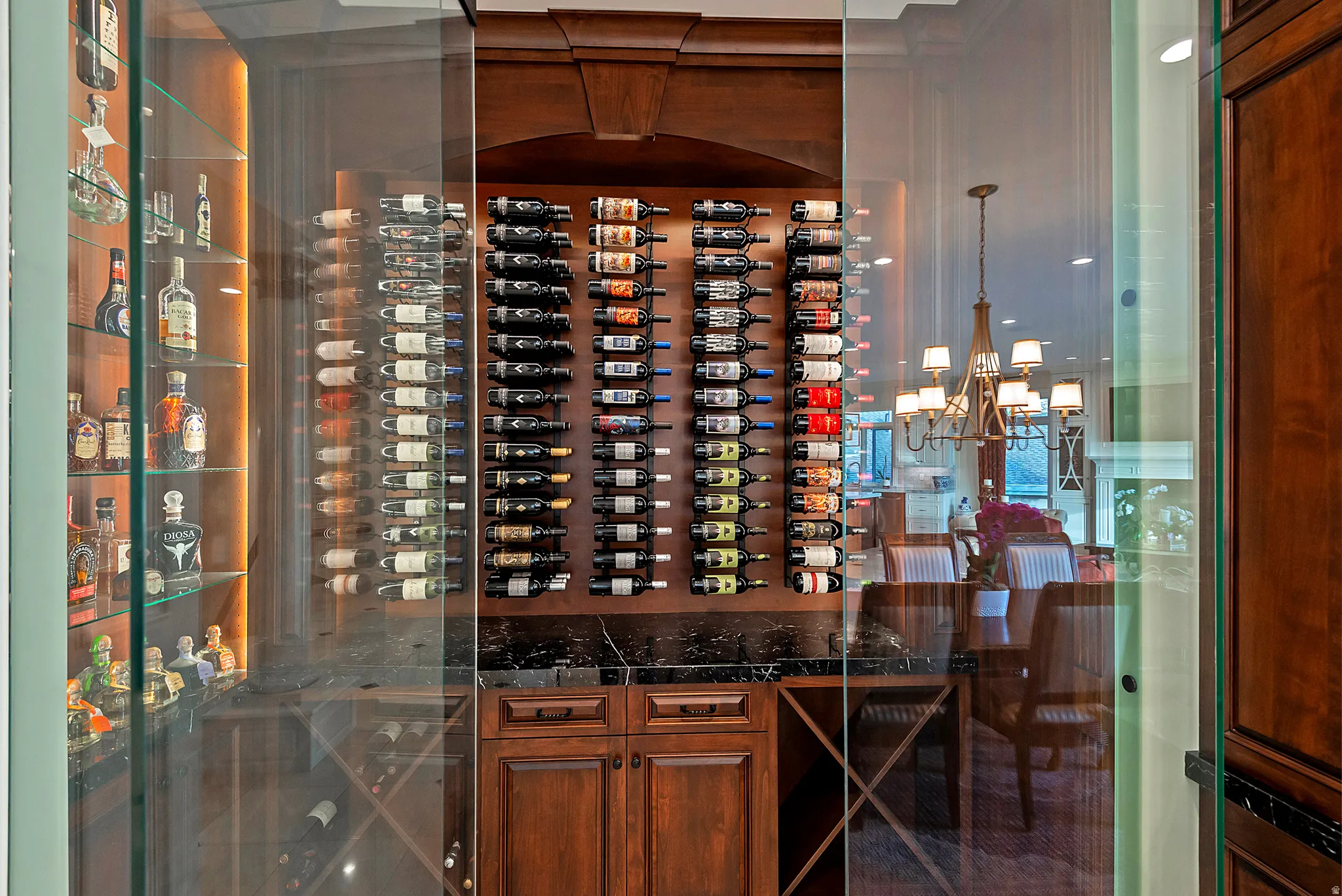 Custom wine storage system featuring glass enclosure and dark wood cabinetry