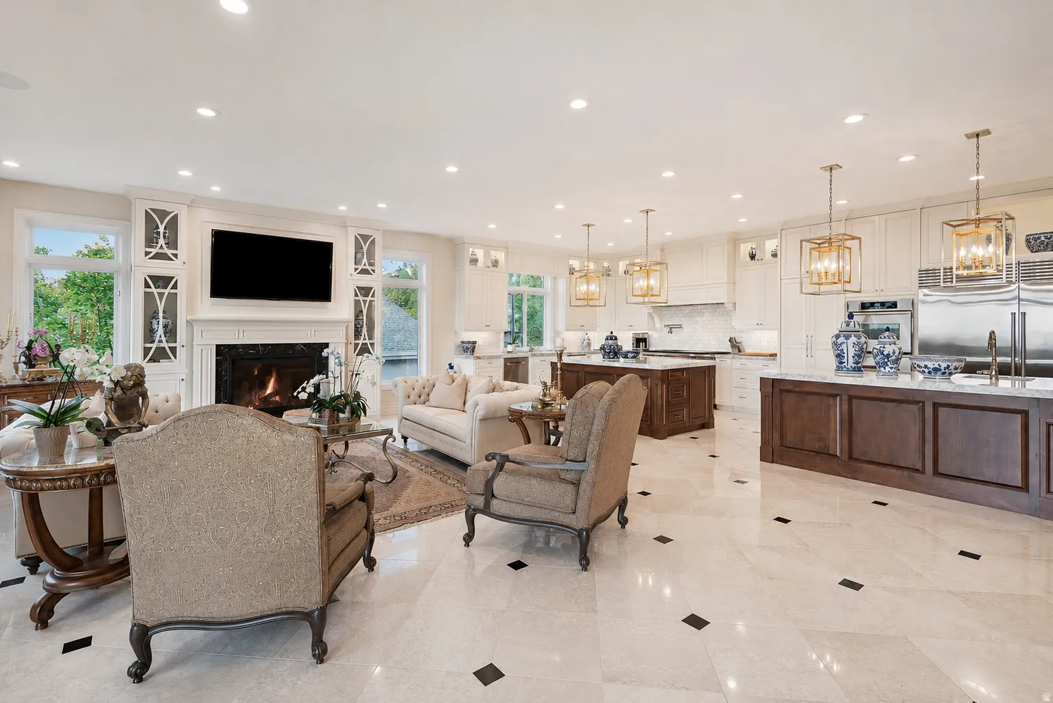 Expansive living area with a fireplace and built-in cabinetry, featuring light-toned flooring with dark accent tiles