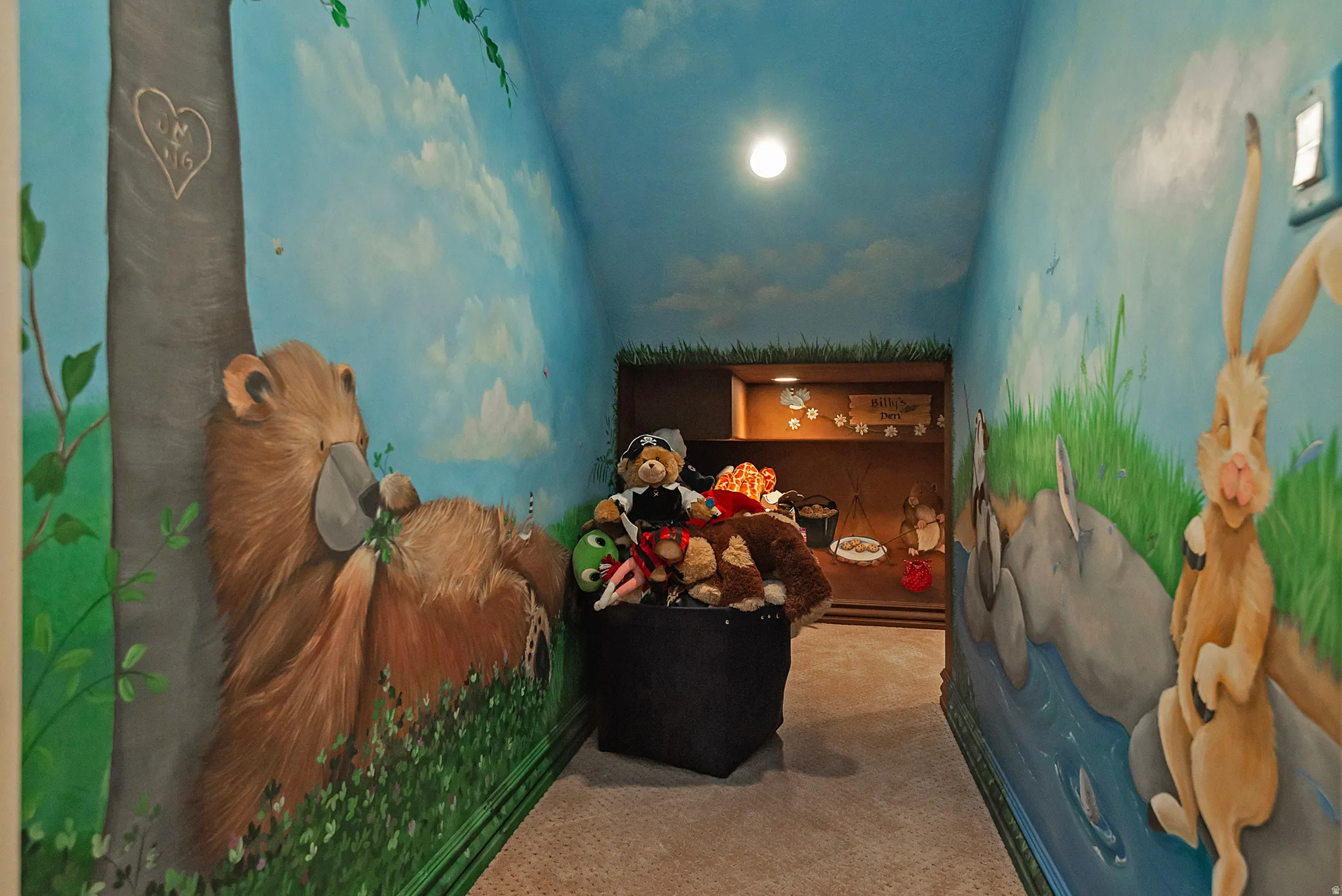 Hallway featuring custom wall murals, recessed display shelving, and integrated overhead lighting