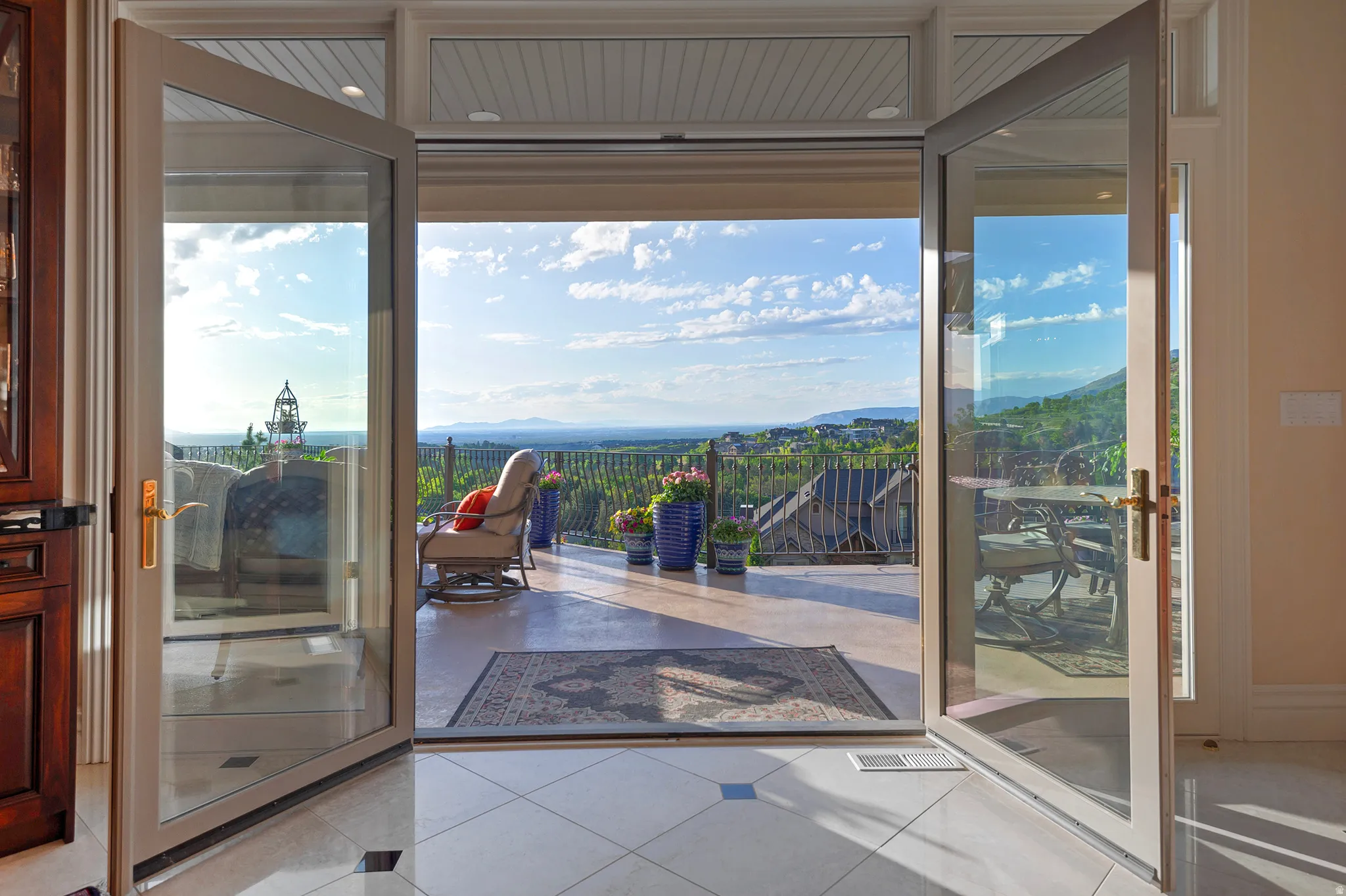 Double French doors opening to an expansive outdoor patio