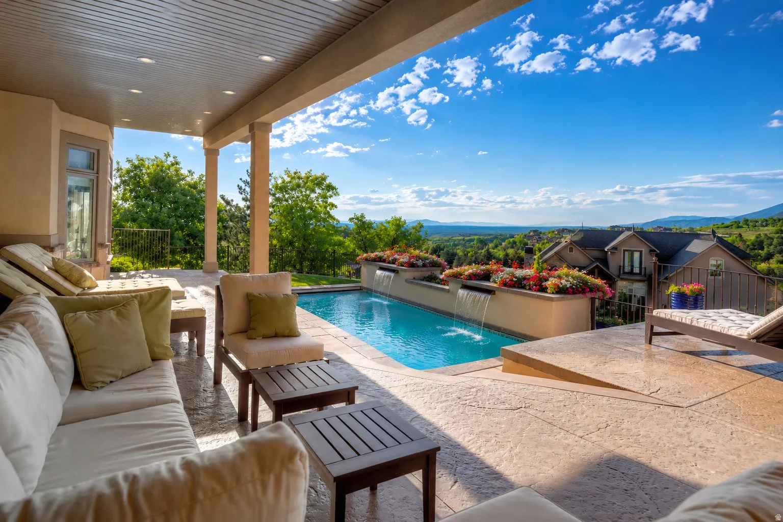 Covered patio with recessed lighting, an integrated swimming pool with waterfalls, and a stamped concrete deck