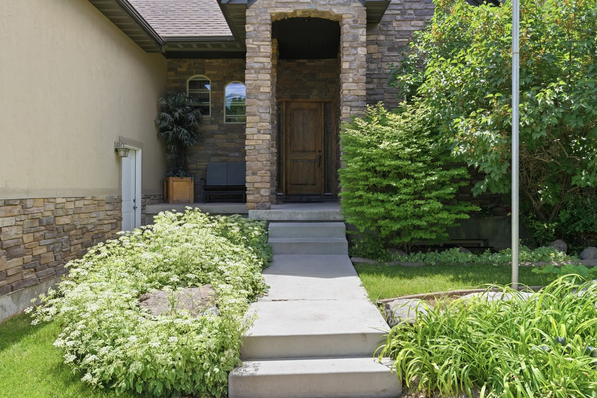 Stone and stucco exterior with a prominent arched entry