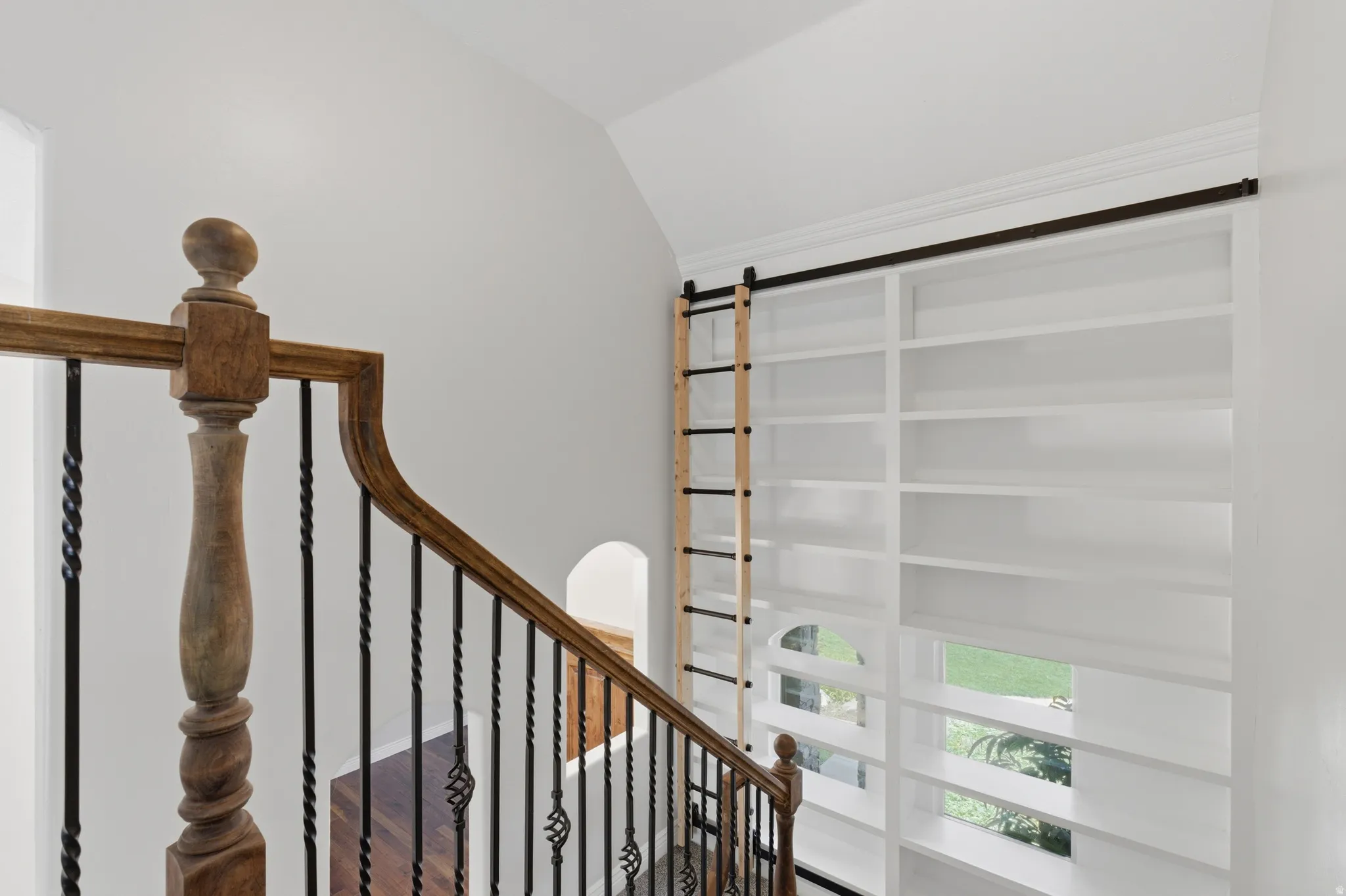 Built-in white shelving with rolling ladder system