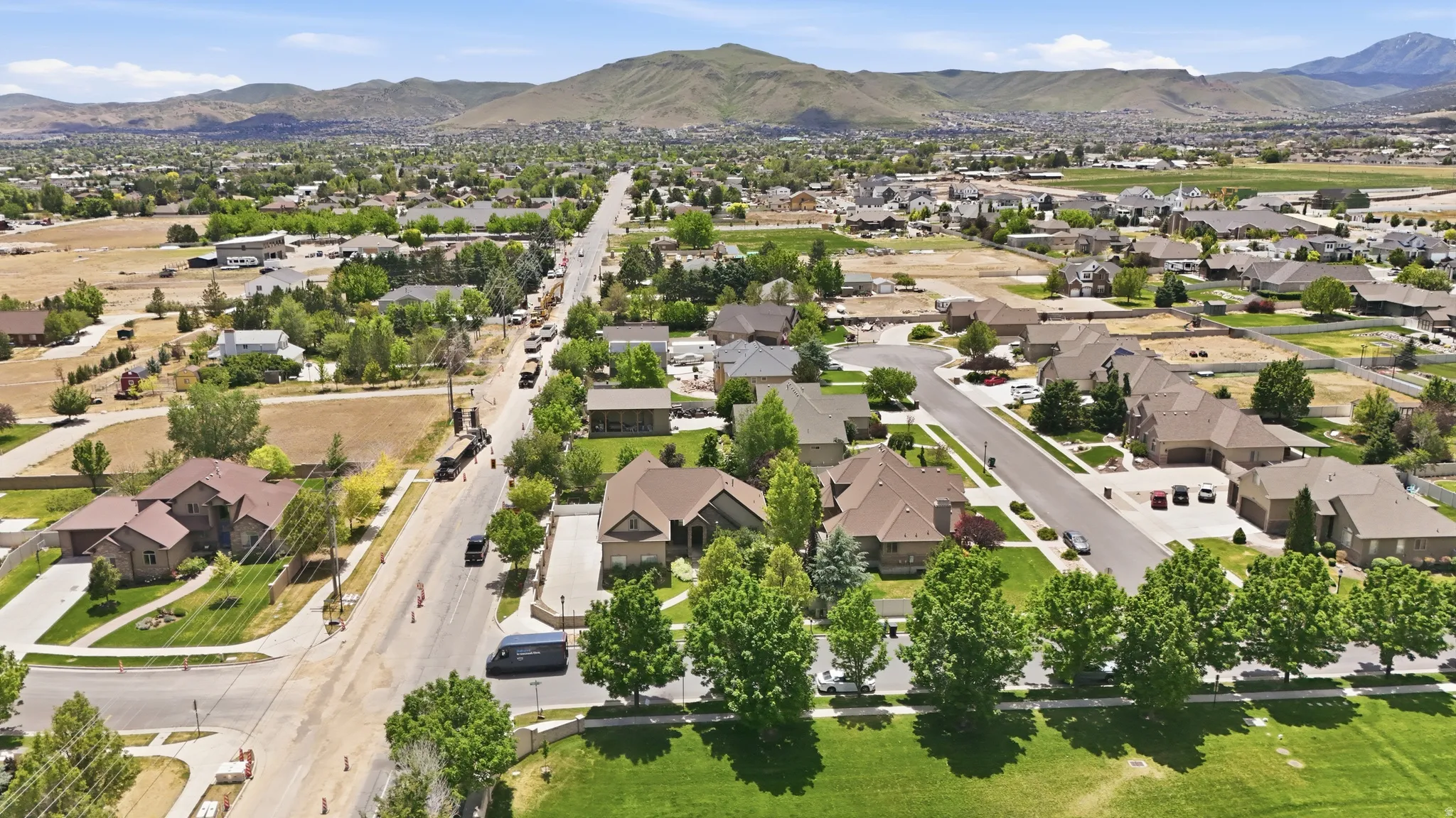 Residential area featuring a variety of single-family homes with mature landscaping and mountain backdrops