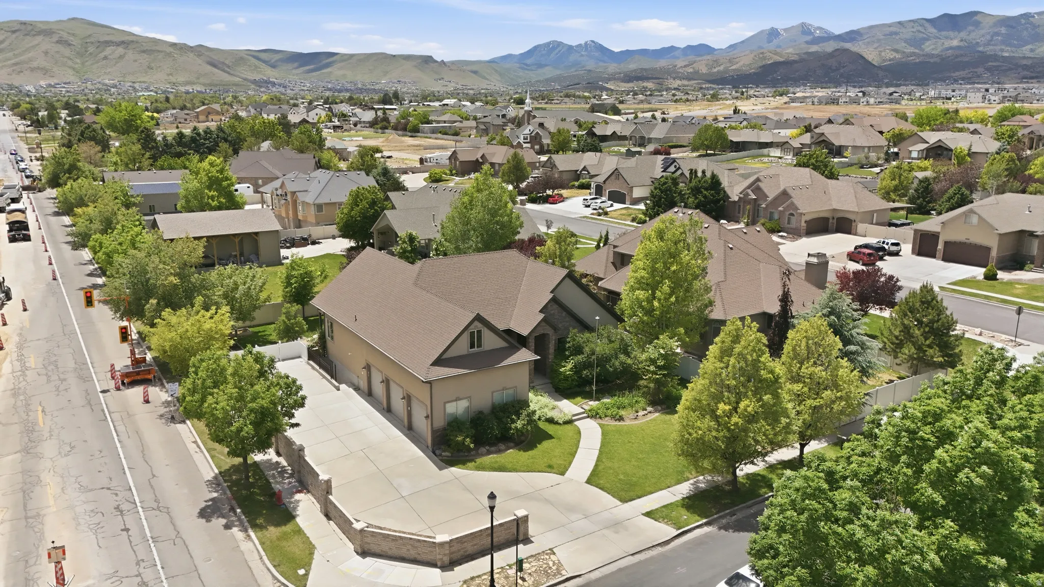 Aerial perspective showcasing a residential neighborhood with mountain backdrops
