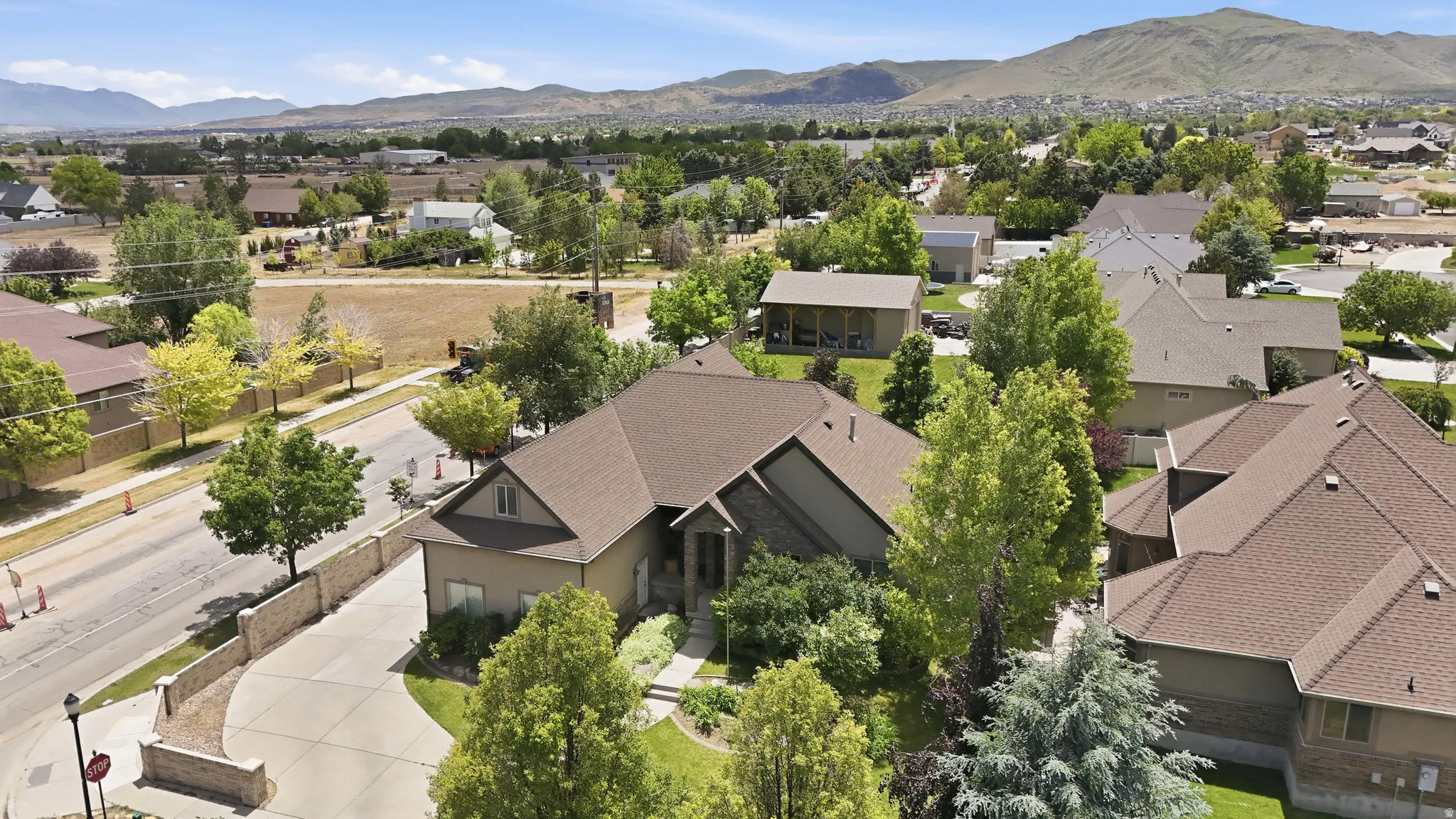 Suburban residence with a multi-gabled roof and stone facade accents