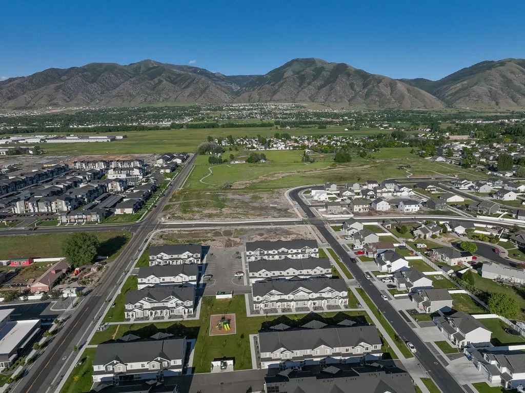 Expansive aerial perspective showcasing a residential development with a mountain backdrop