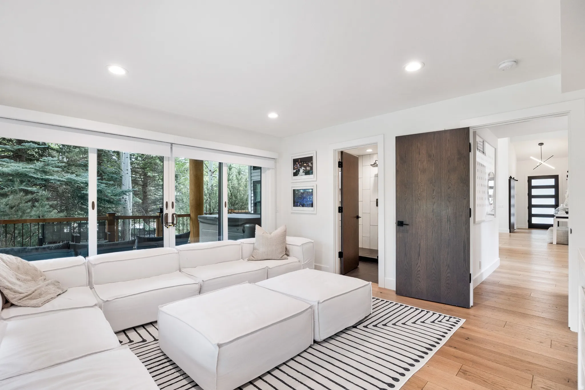 Open-concept living area featuring light wood flooring and recessed lighting