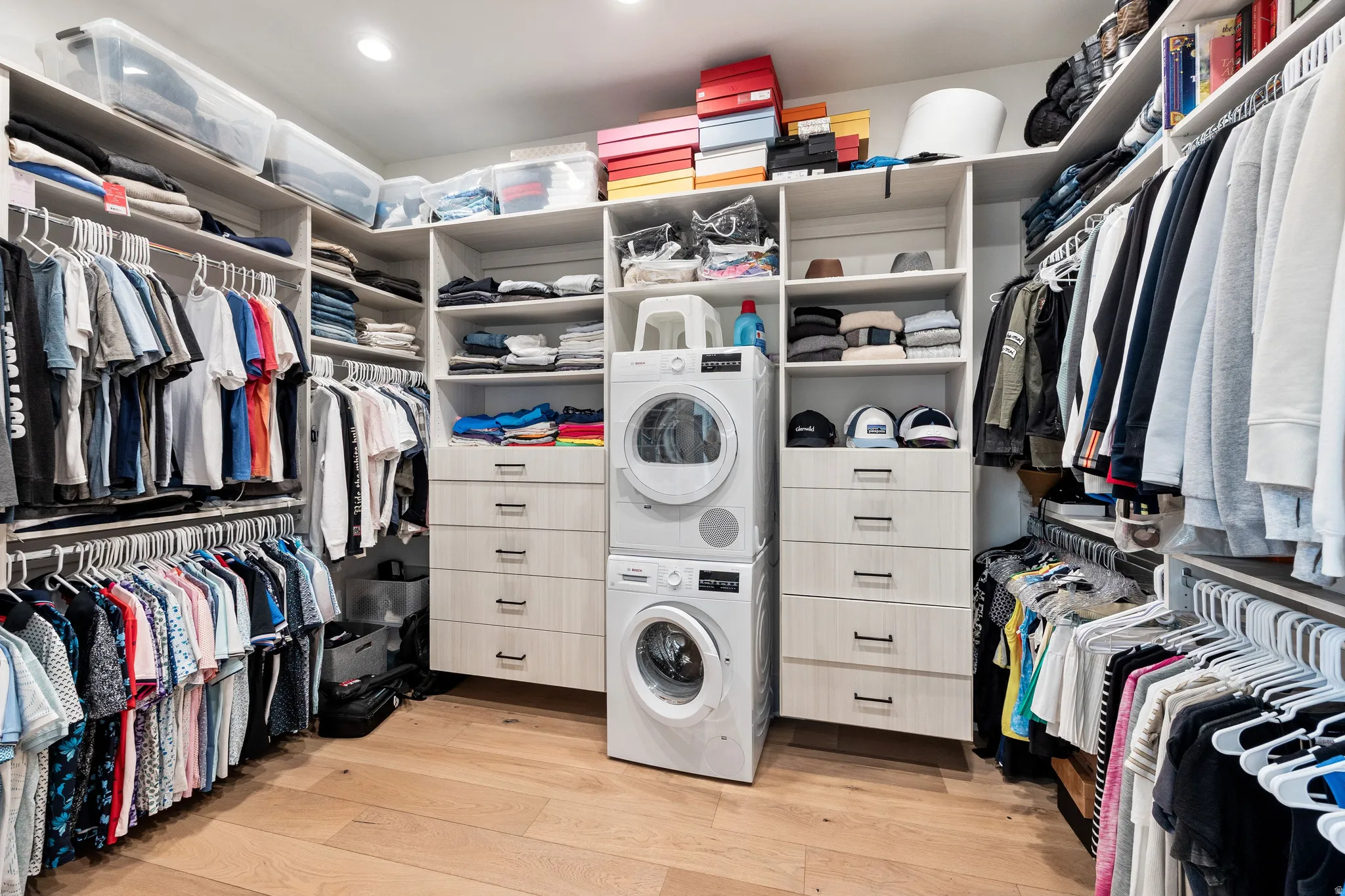 Custom closet system featuring built-in shelving, hanging rods, and integrated drawer units