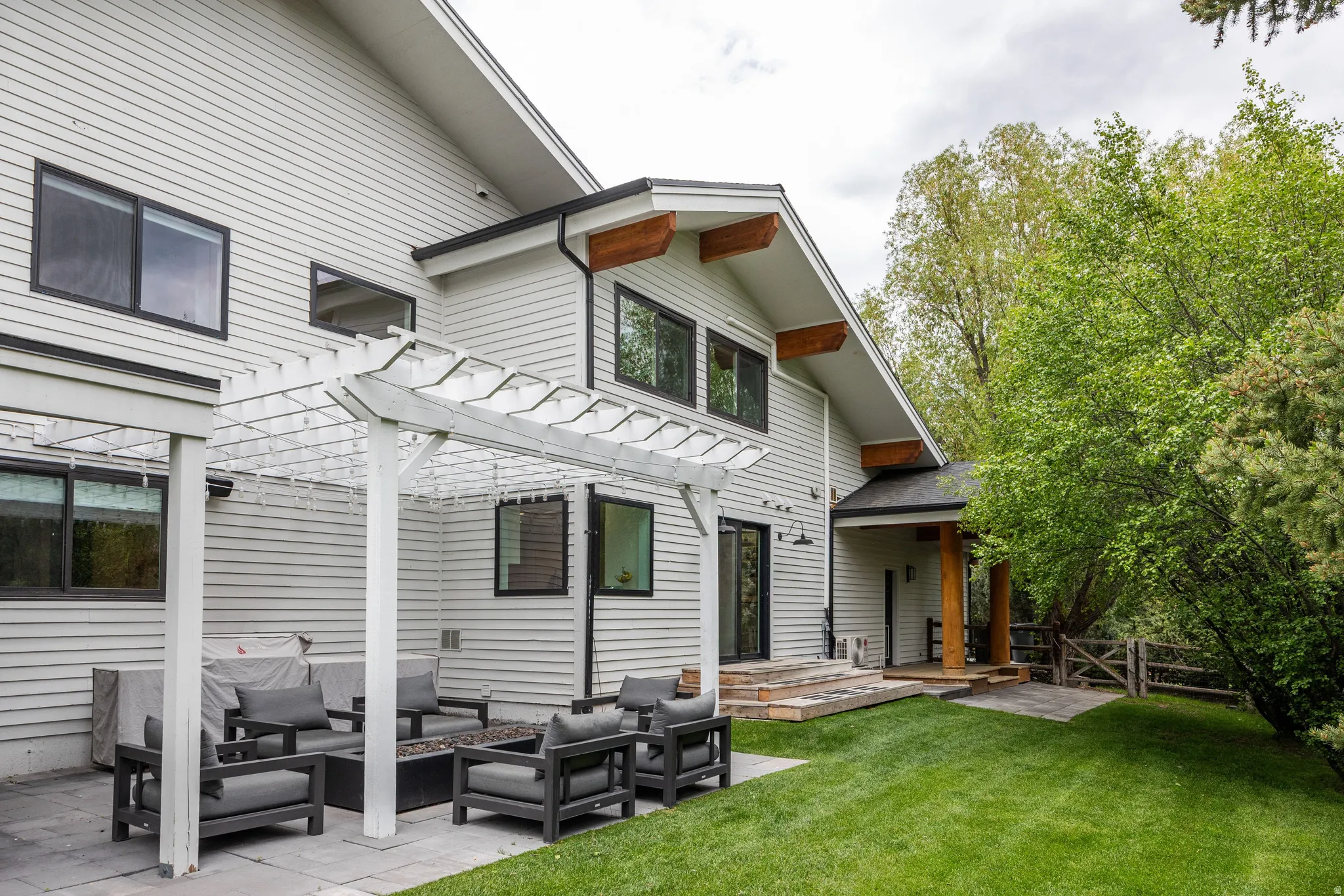 Exterior featuring light-colored horizontal siding and black-trimmed windows