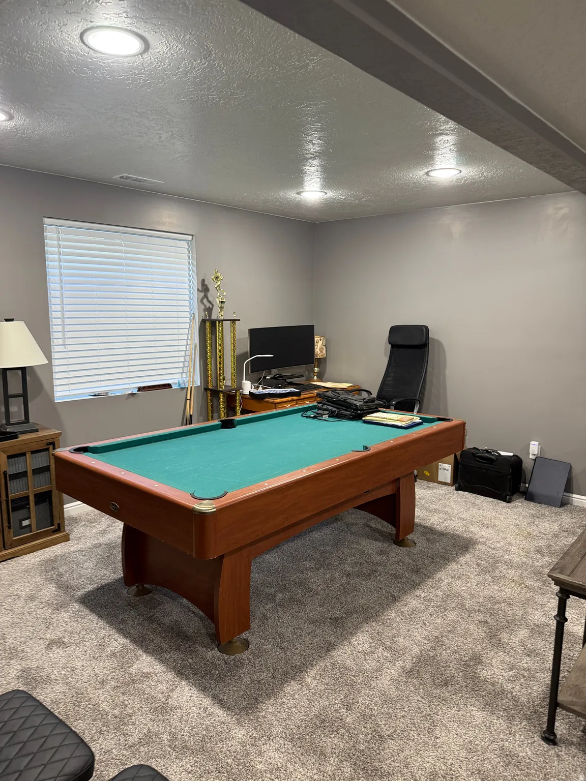 Recreational space featuring a billiards table with a wood frame and green felt surface