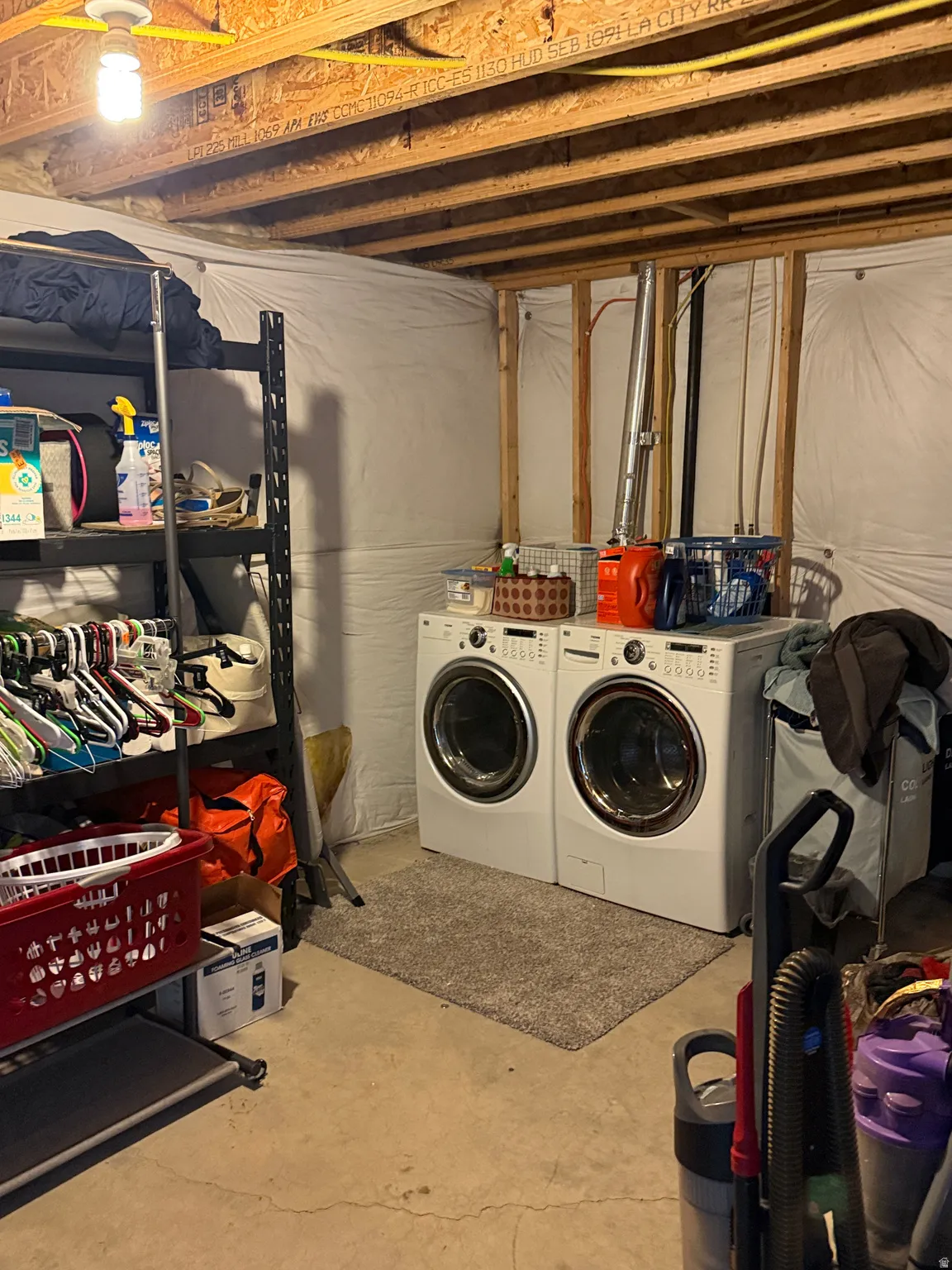 Dedicated laundry area featuring front-loading washer and dryer units