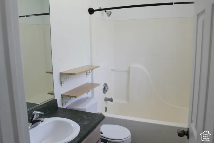 White bathtub with an integrated shower, featuring a black shower rod