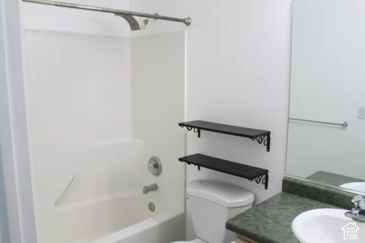 Full-size bathtub with integrated shower, chrome fixtures, and white surround