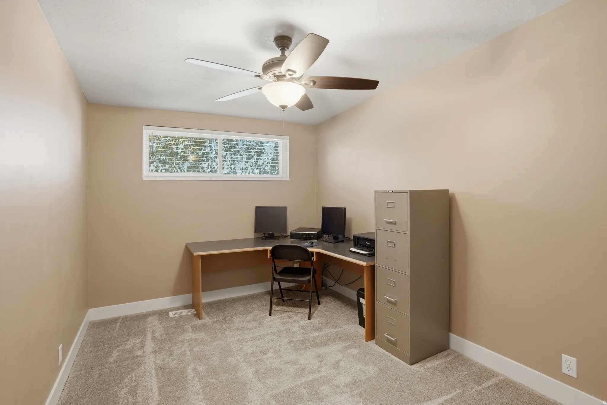 Light-colored walls defining the interior space, complemented by a horizontal window providing natural light