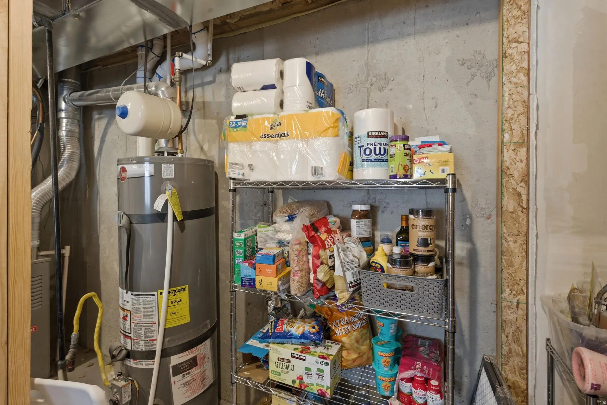 Water heater installation with exposed ductwork and concrete walls