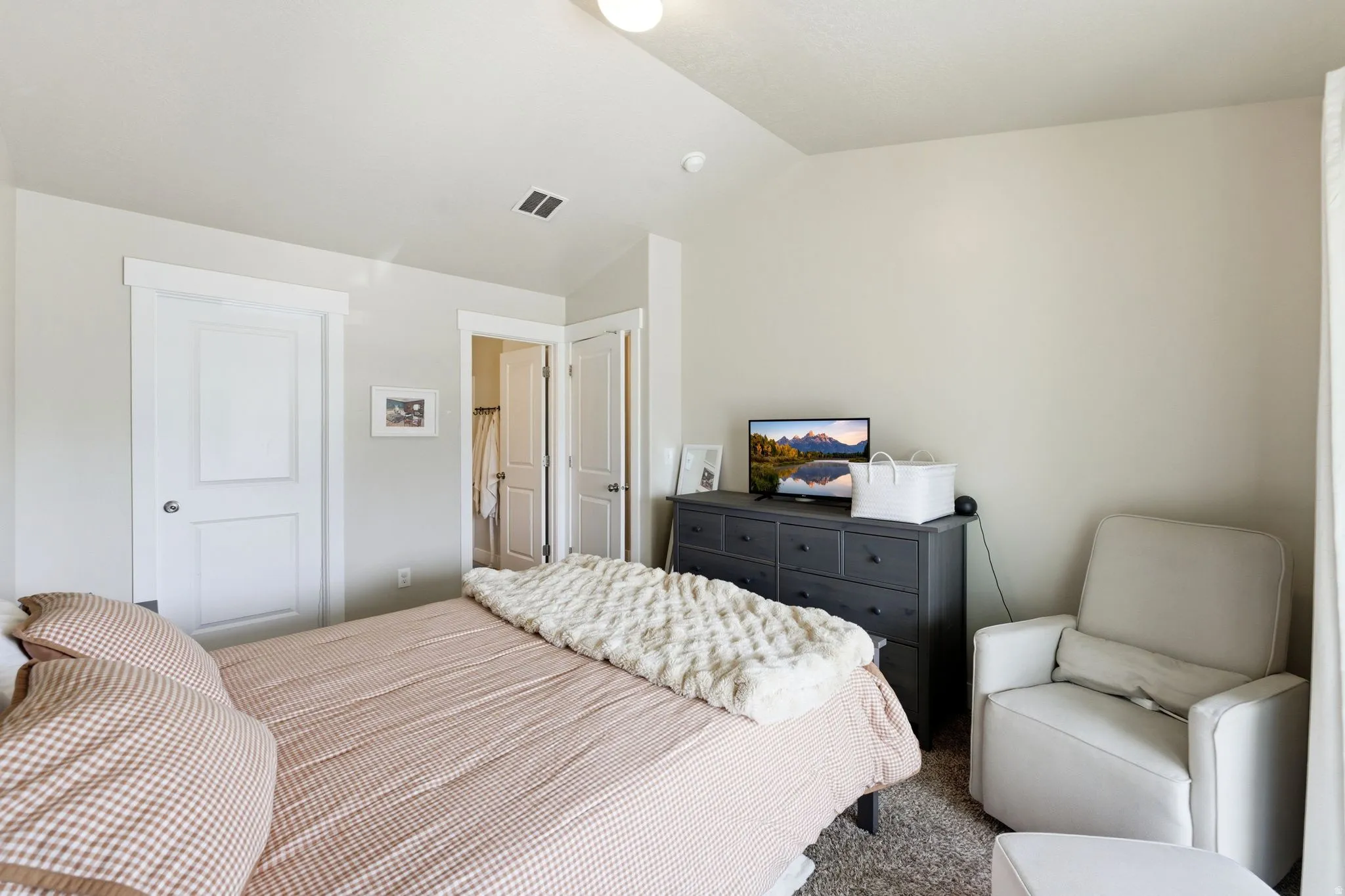 Carpeted bedroom featuring white trim, two-panel doors, and neutral wall tones