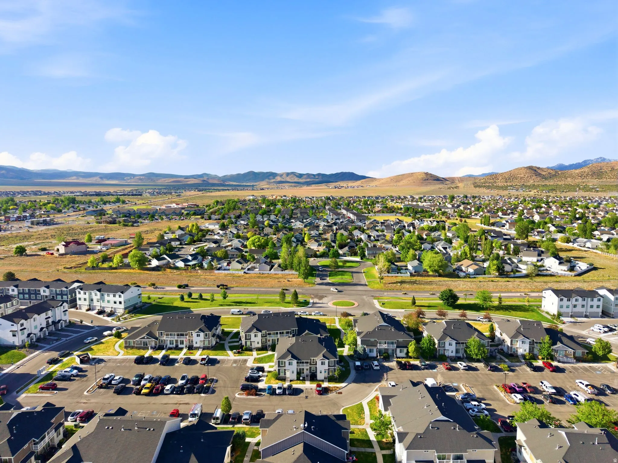Expansive aerial perspective showcasing a residential community with multi-story buildings and detached homes