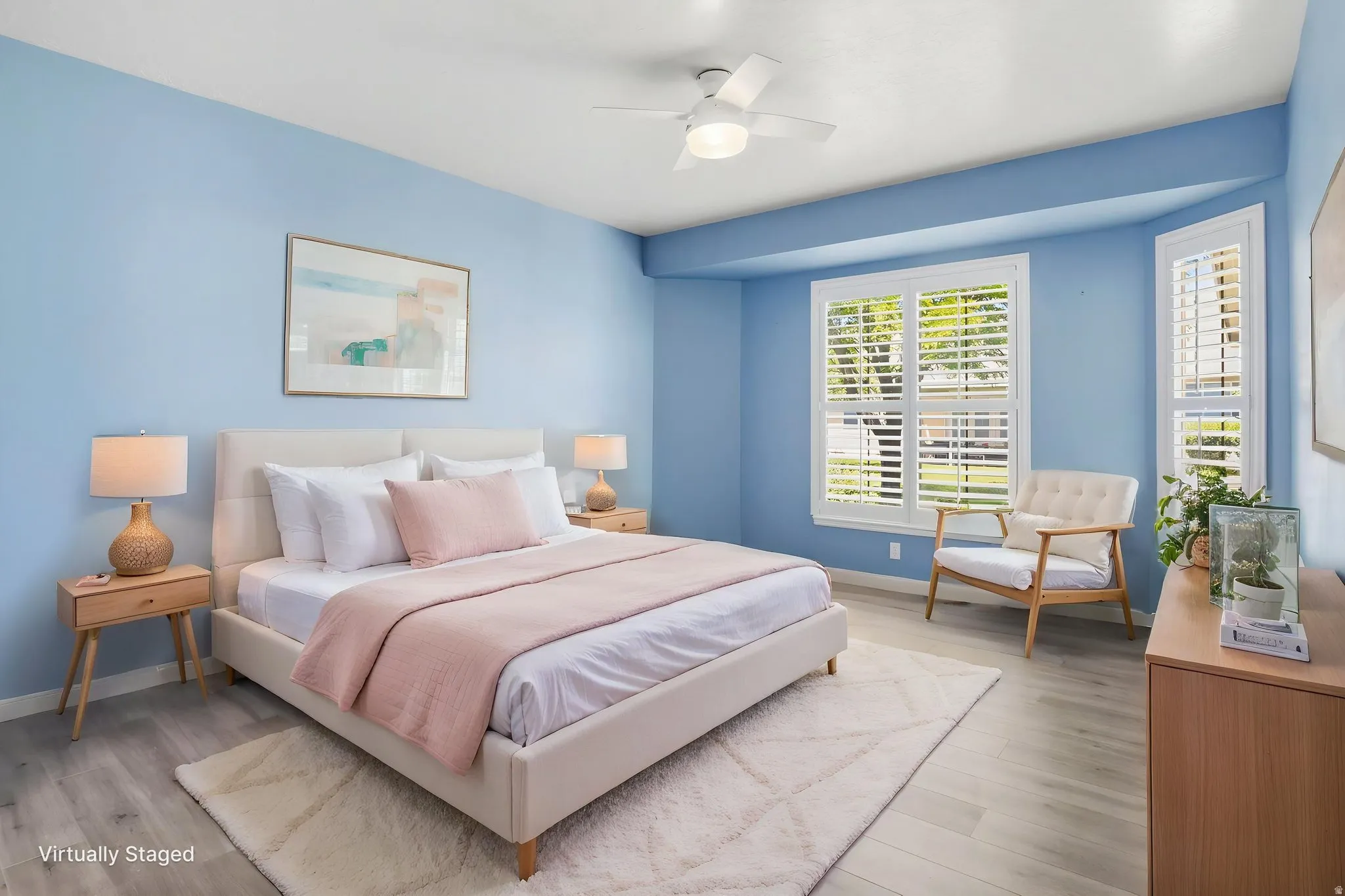 Master Bedroom, Virtually Staged: Spacious room featuring wood-finish flooring, a ceiling fan, and multiple windows with plantation shutters