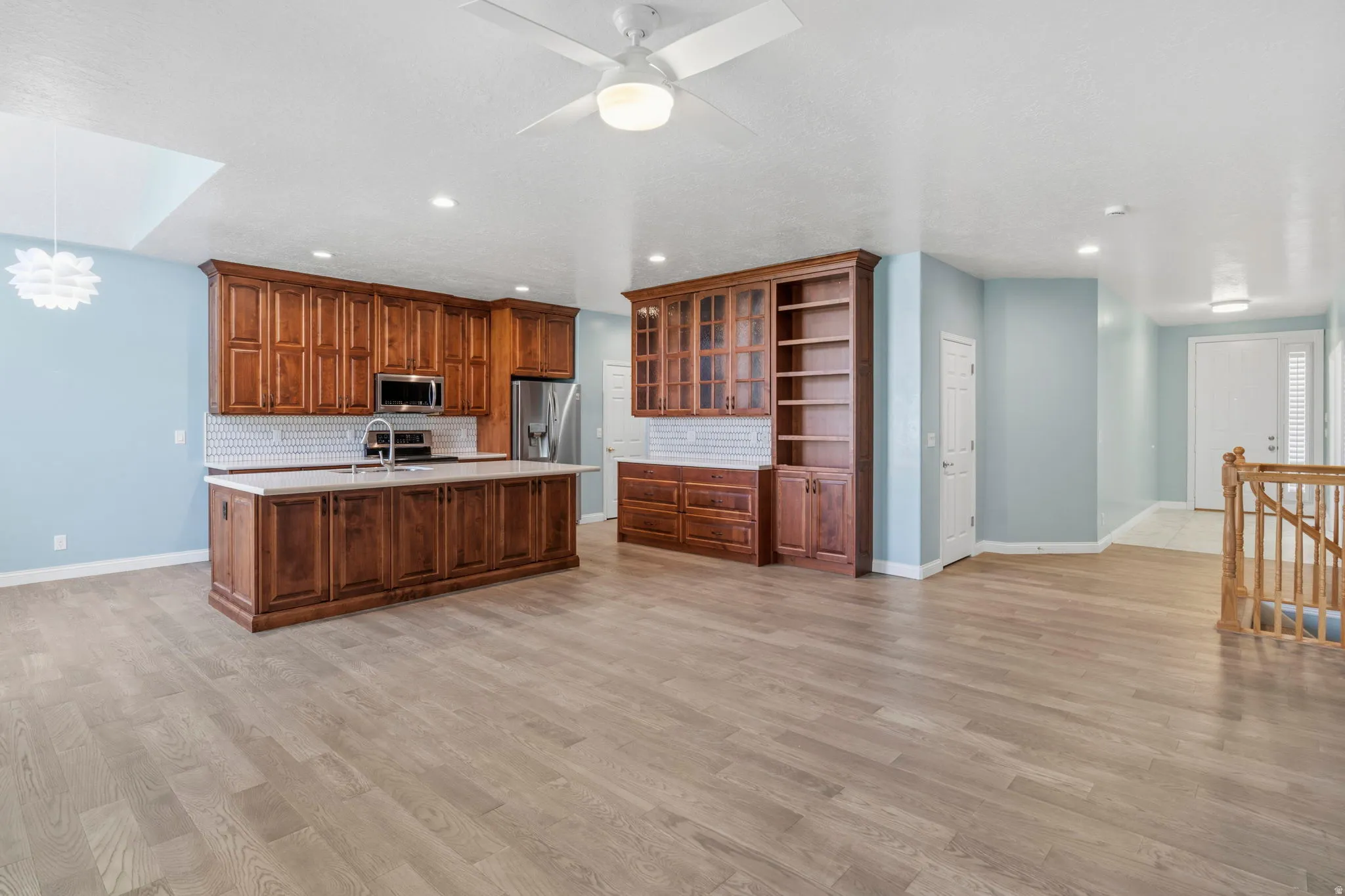 Open concept living area featuring wood-finish flooring