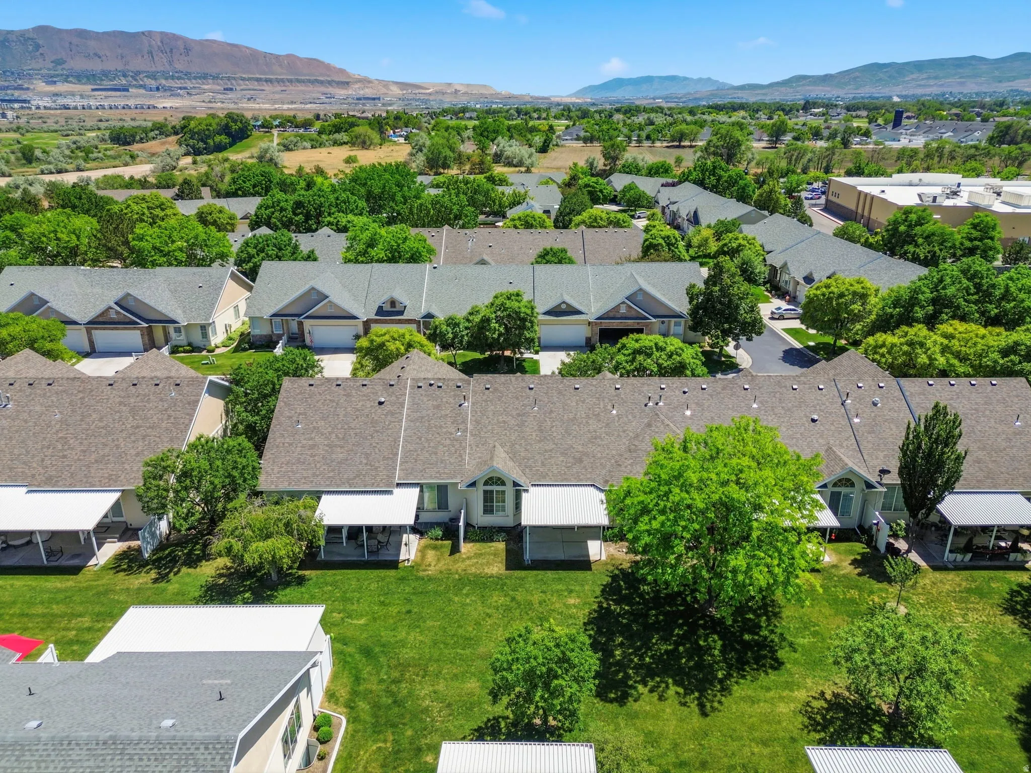 Aerial perspective showcasing a residential community with abundant mature trees and verdant green spaces