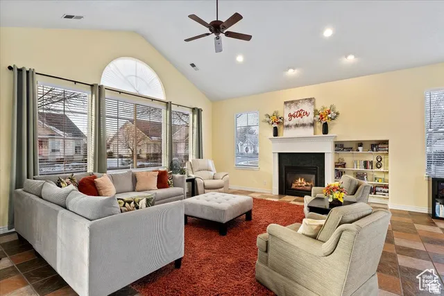 Club House Spacious living area featuring vaulted ceilings, a ceiling fan, and recessed lighting