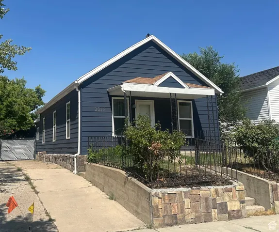 Blue horizontal siding exterior with white trim and a contrasting brown roof