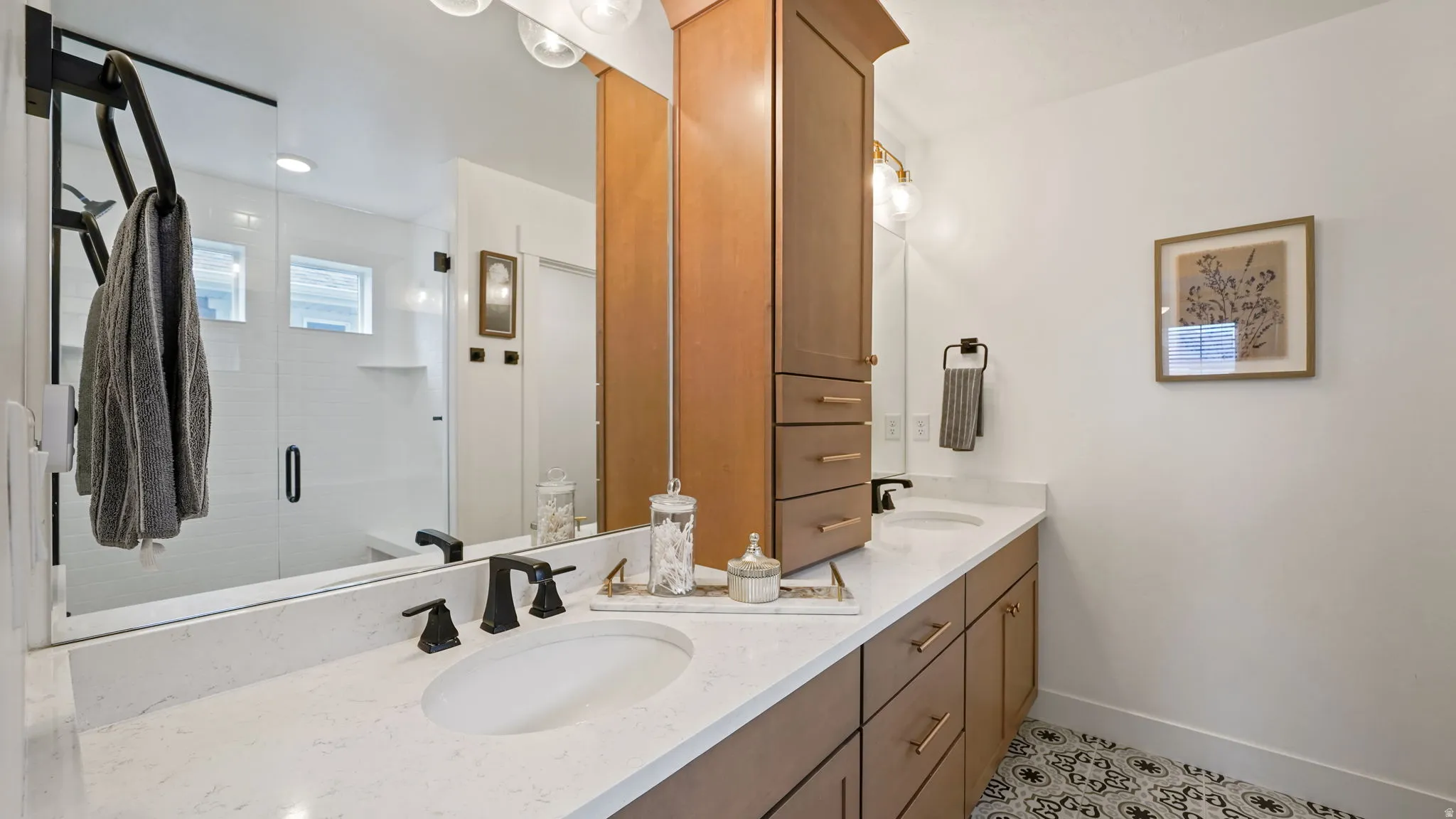 Dual vanity with white countertops, undermount sinks, and matte black fixtures