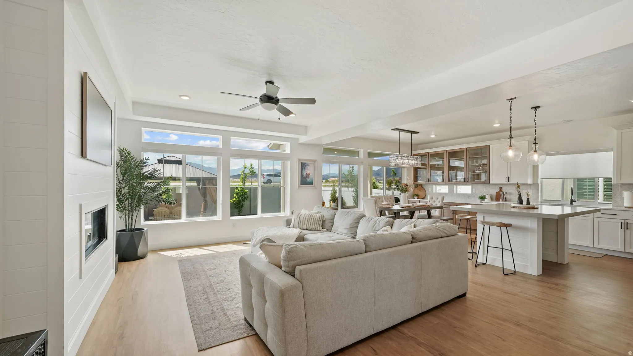 Expansive open-concept living space with wood-finish flooring
