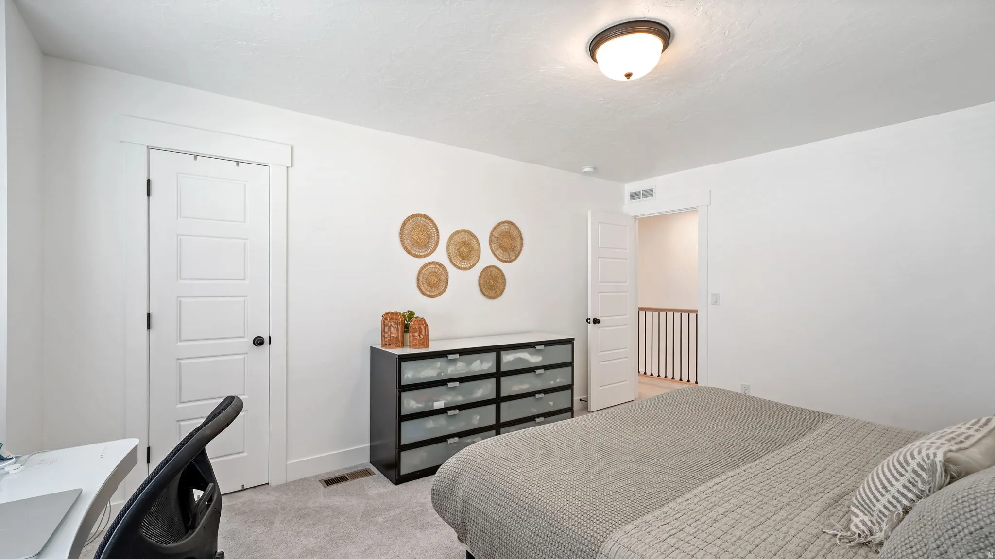 Neutral painted walls with white trim, five-panel interior doors, and a ceiling-mounted light fixture