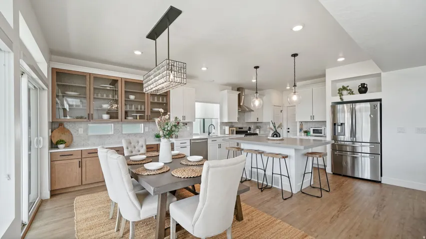 Open-concept kitchen and dining area featuring light wood-finish flooring