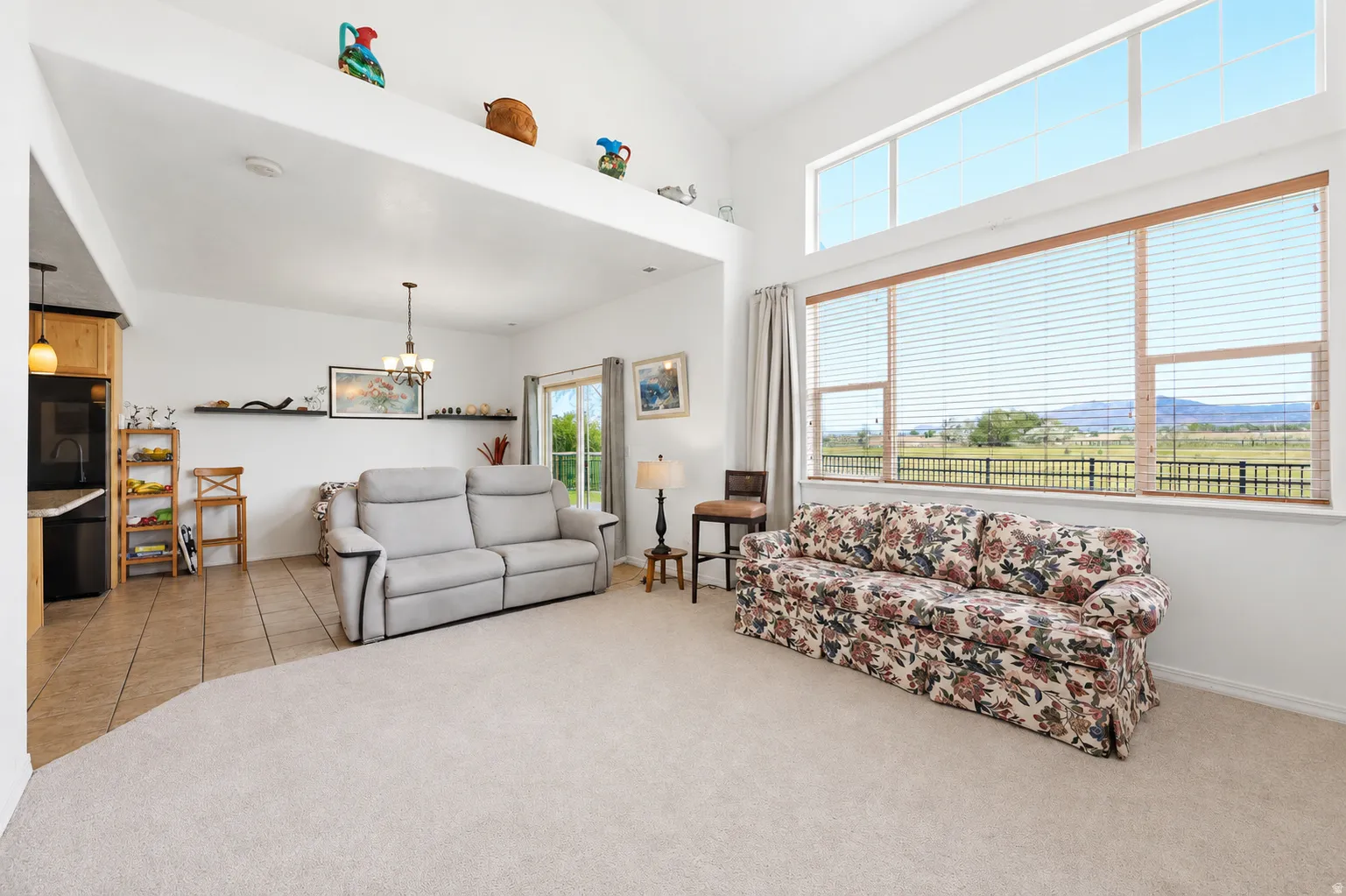 Living area featuring expansive windows, high ceilings creating the ideal great room!