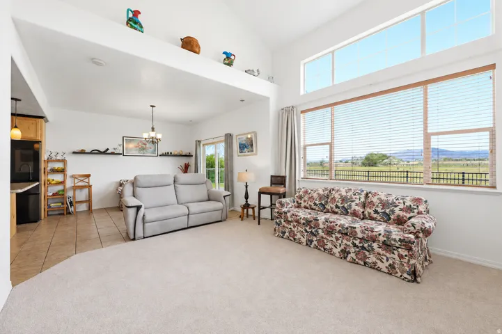 Living area featuring expansive windows, high ceilings creating the ideal great room!