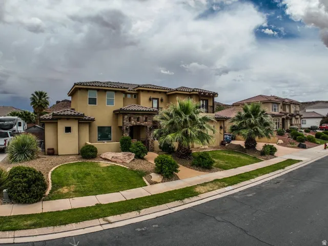 Stucco exterior with stone accents and a terracotta tile roof