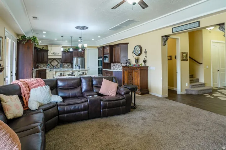 Open concept living area with carpeting and wood-finish flooring