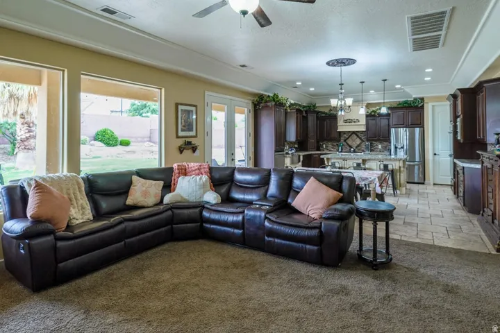 Open-concept living area featuring a kitchen with dark wood cabinetry and a central island