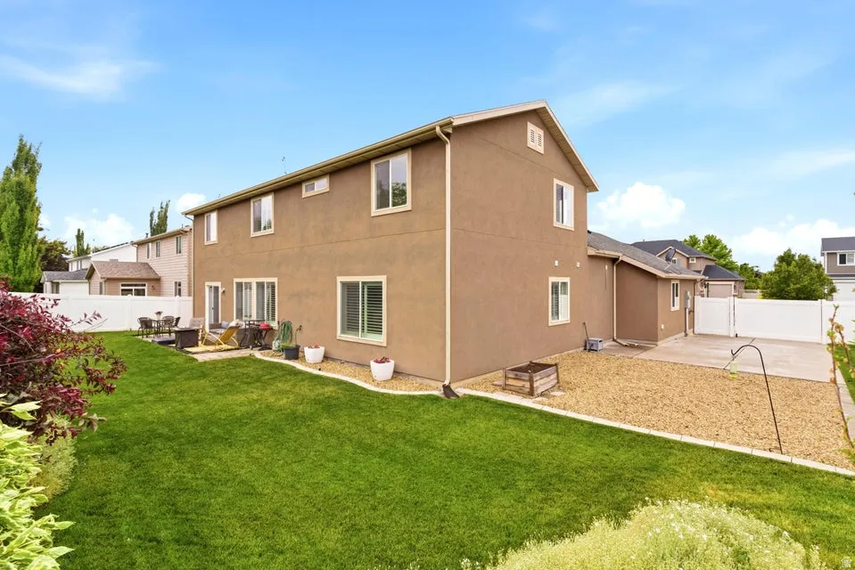 Expansive green lawn with established landscaping, offering a private outdoor environment