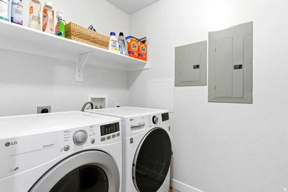 Dedicated laundry area with white walls and a built-in white shelving unit
